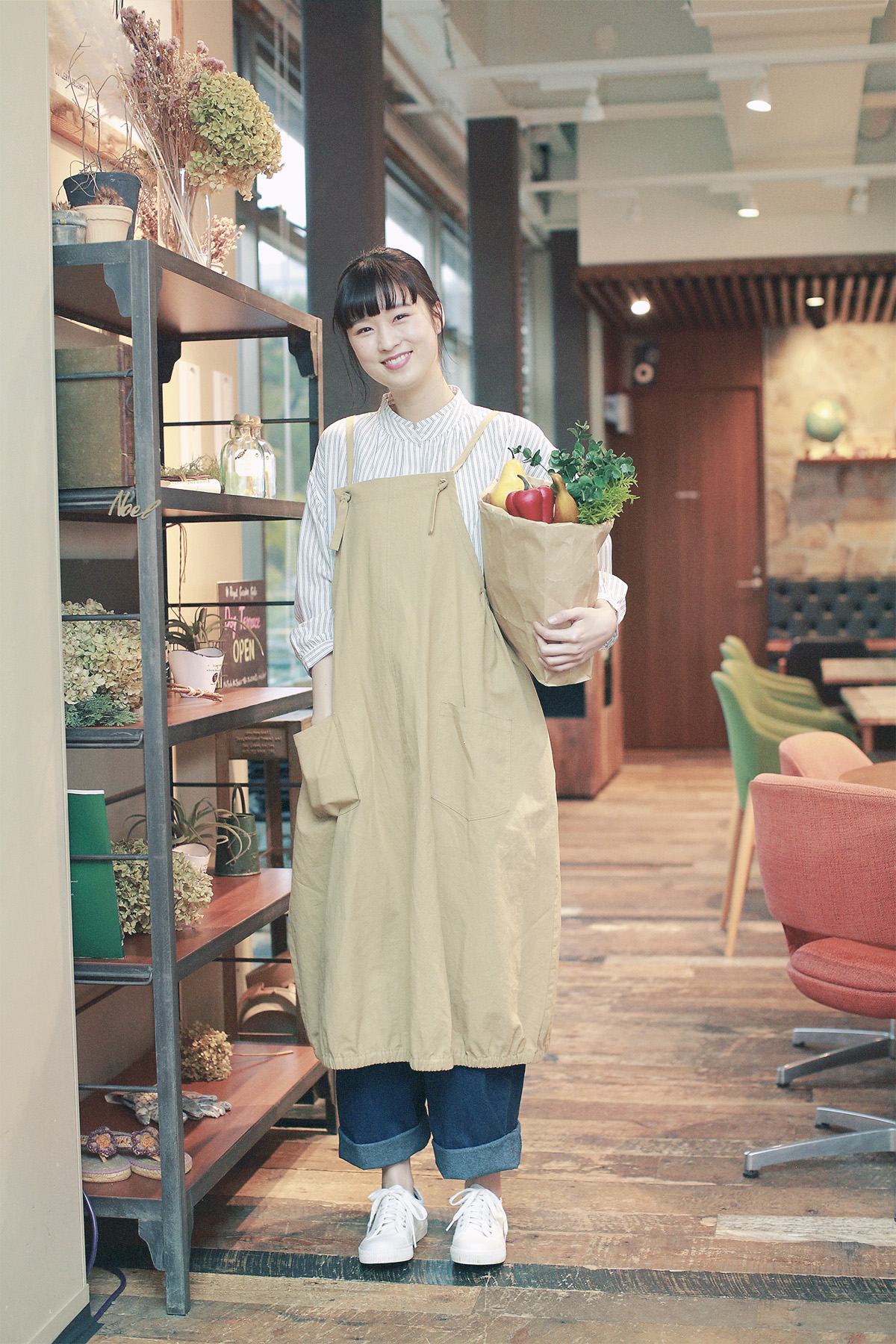 エプロンとストライプシャツの女性モデル写真